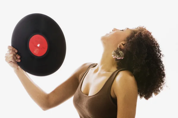Woman dancing with record album