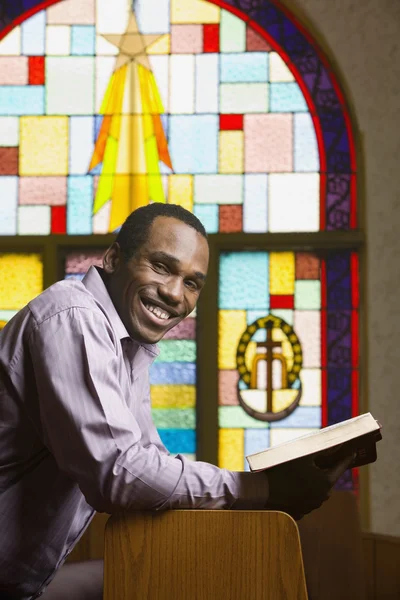 African American man with Bible in church