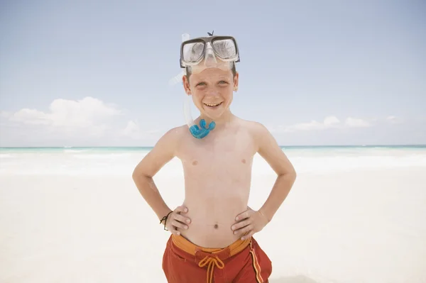 Young boy with snorkel smiling at the beach