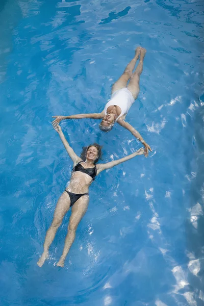 Two women floating in water
