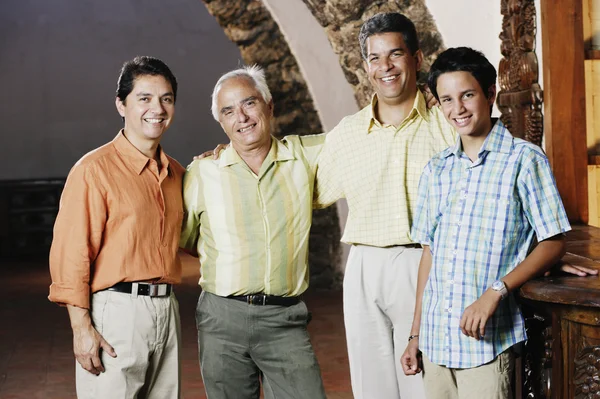 Male members of a family smiling for the camera