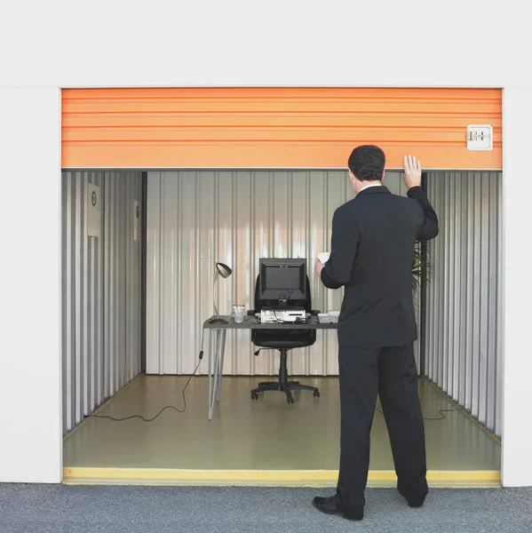 Businessman closing door of storage unit office