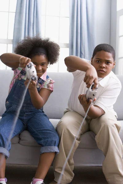 African American sister and brother playing video games