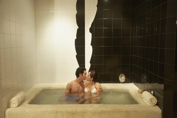 Couple kissing in spa hot tub