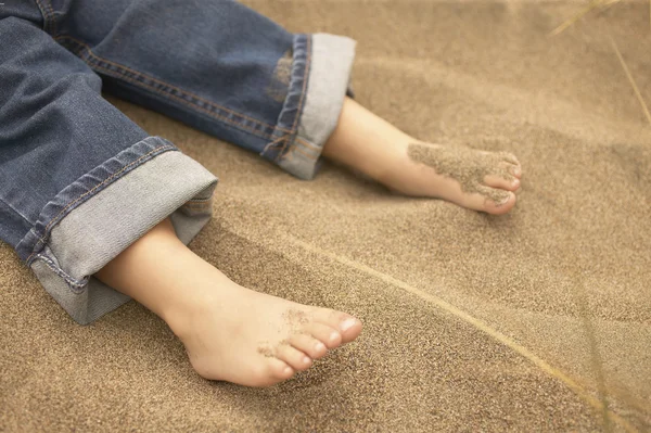 Toddler\'s feet in sand