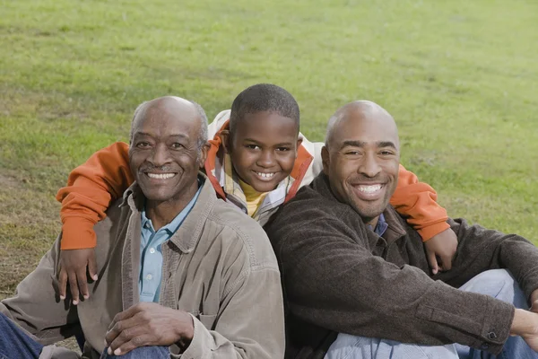 African American family smiling outdoors