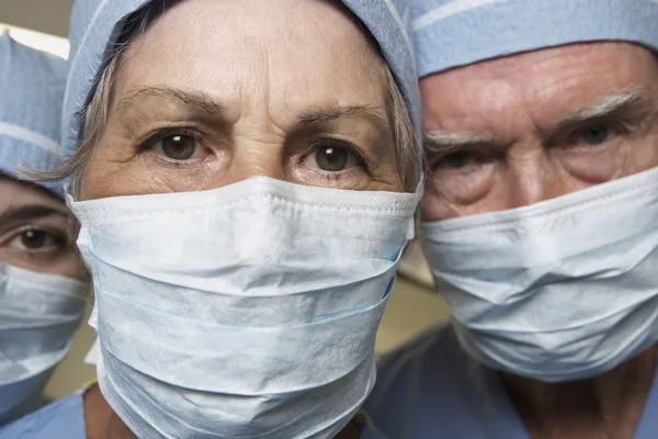 Close up of senior male and female doctors in surgical masks