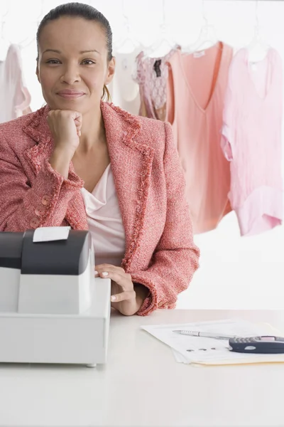 Portrait of woman at register in clothing store