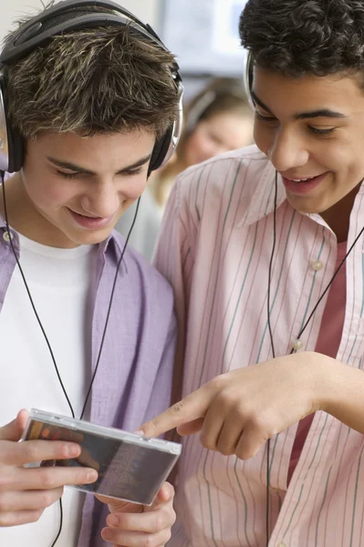 Two teenage boys with headsets listening to music