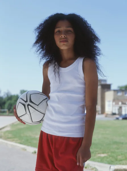 Portrait of girl holding soccer ball