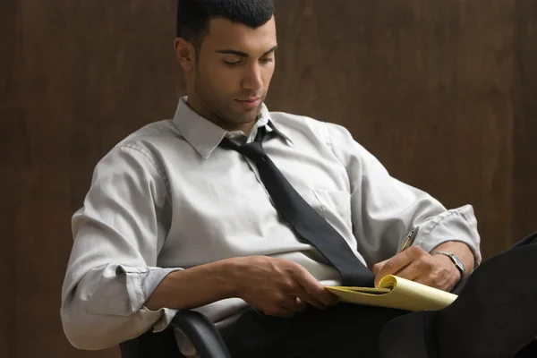 Businessman sitting and writing notes