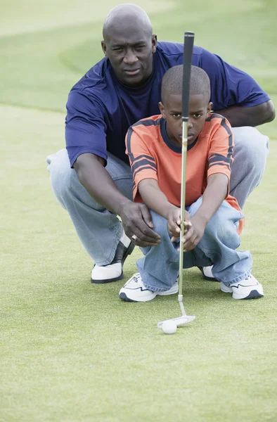Father and son on golf course