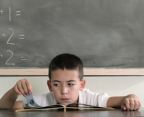 School boy reading book