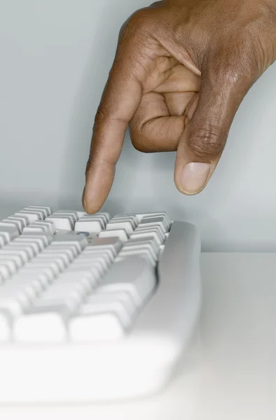 Close up of hand on computer keyboard