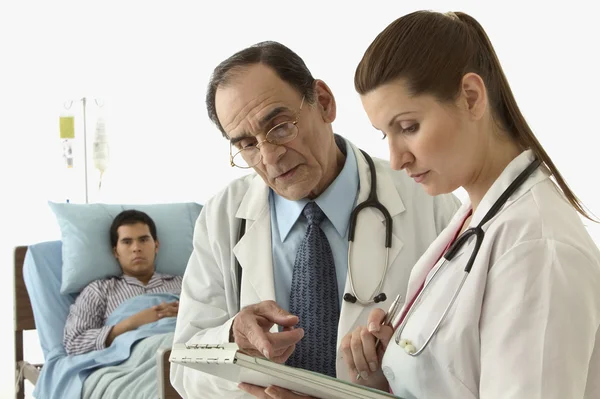 Doctors discussing a patient\'s medical chart