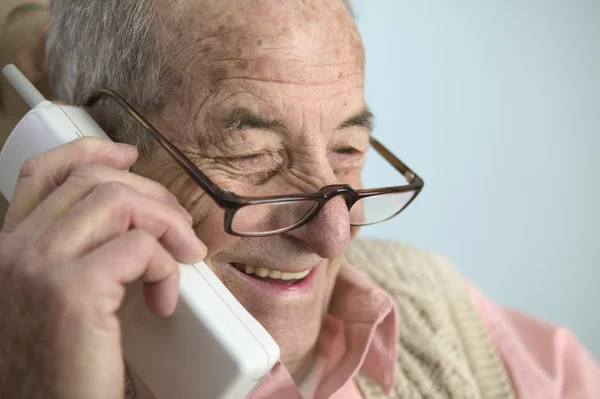 Elderly man talking on cell phone