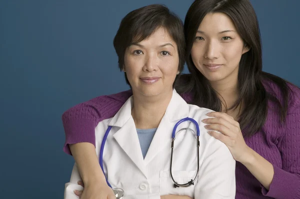 Doctor posing for the camera with her daughter