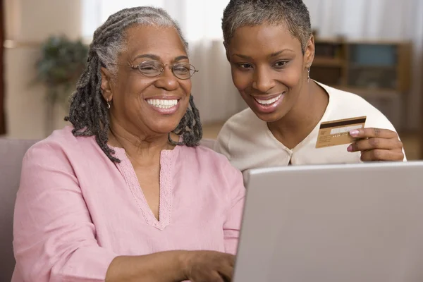 Mother and daughter ordering online with credit card