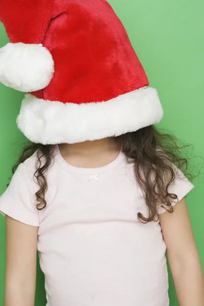 Girl with Santa hat pulled down over face