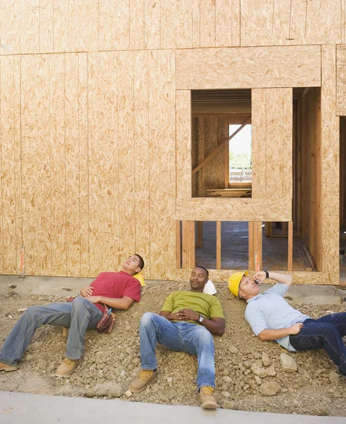 Male construction workers relaxing at construction site