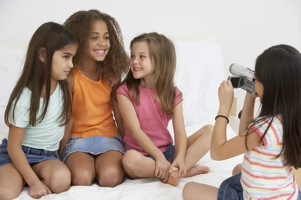 Group of young girls using video camera