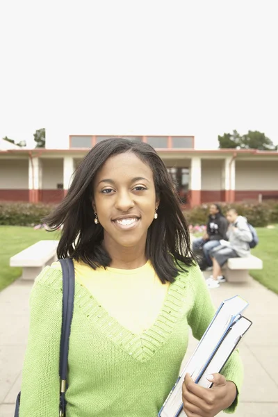 Young African woman smiling on school campus