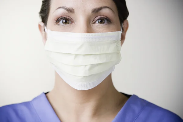 Hispanic female doctor wearing surgical mask
