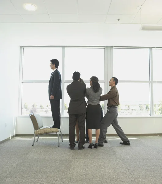 Coworkers performing trust building exercise