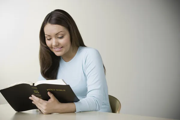 Hispanic woman reading bible