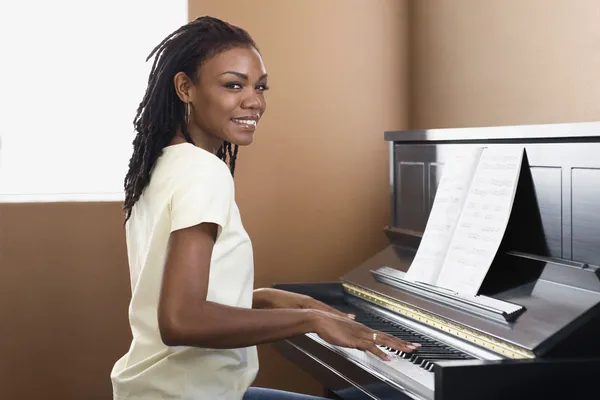 African woman playing piano