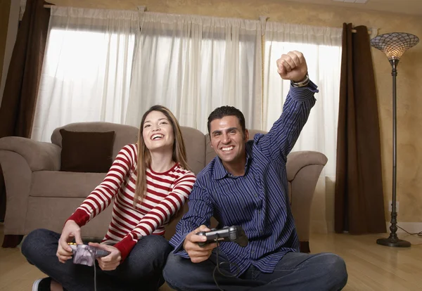 Hispanic couple playing video game