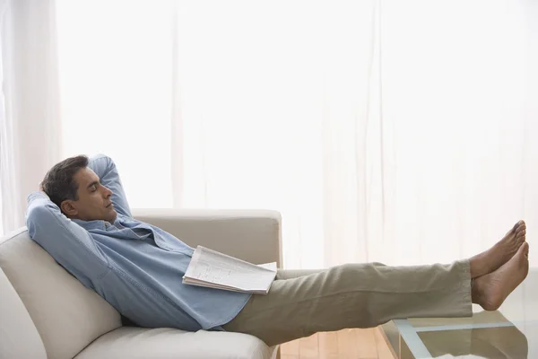 Hispanic man sleeping on sofa