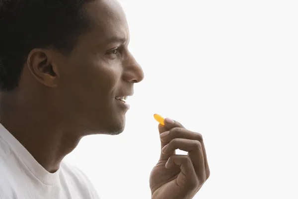 African American man taking vitamin