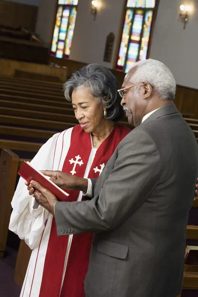 African American female Reverend talking to parishioner