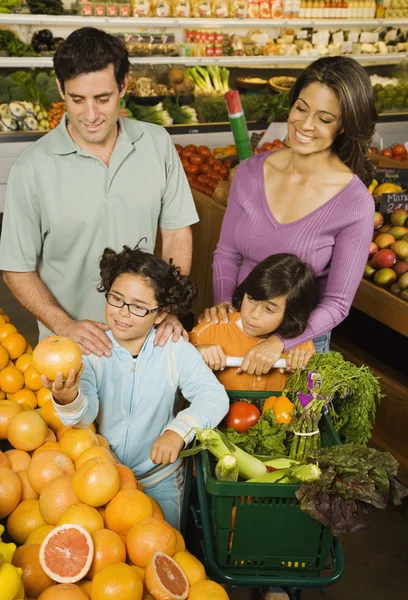 Hispanic family shopping in grocery store