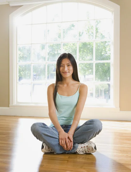 Asian woman sitting in new house