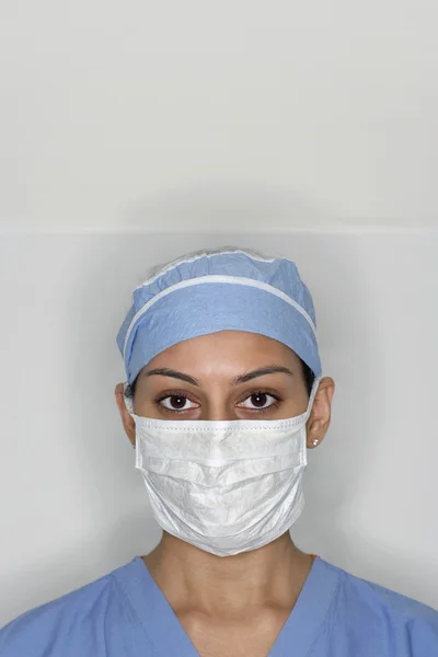 Asian female medical professional wearing surgical mask
