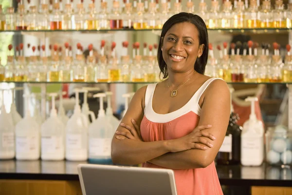 African American female sales clerk at perfume store