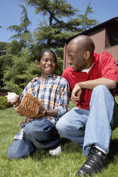 African father and son with baseball glove