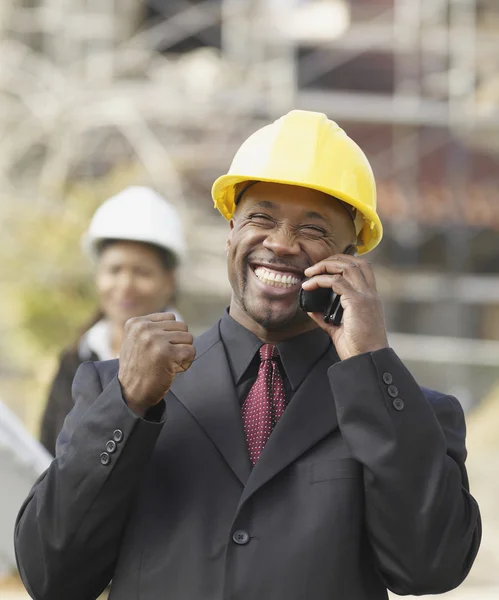 African American businessman cheering on cell phone