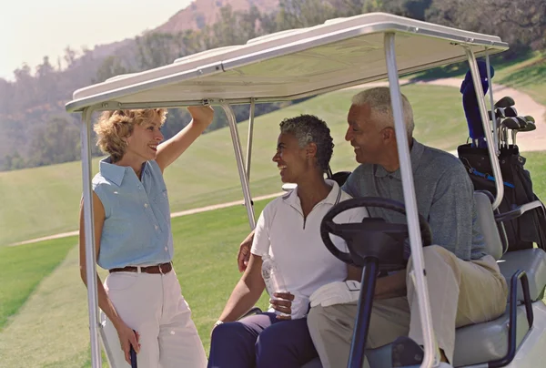 Multi-ethnic seniors on golf course