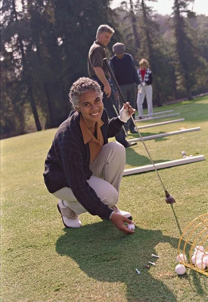 Senior African American woman playing golf