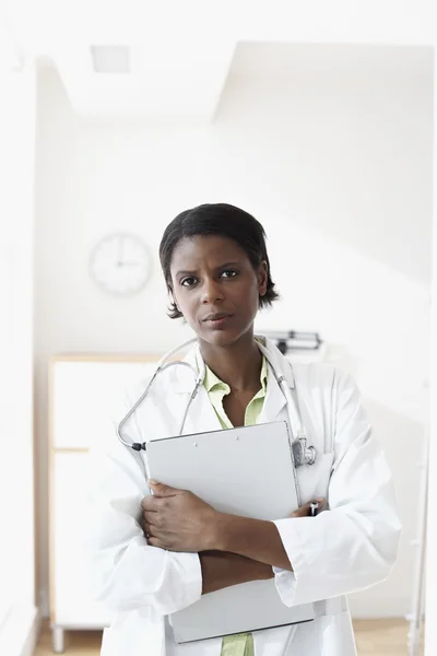 African female doctor holding chart