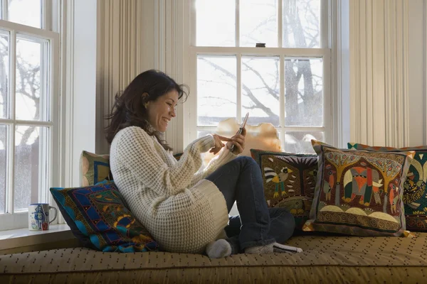 Hispanic woman dialing cell phone