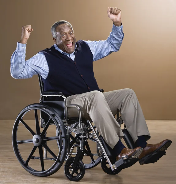 African man cheering in wheelchair