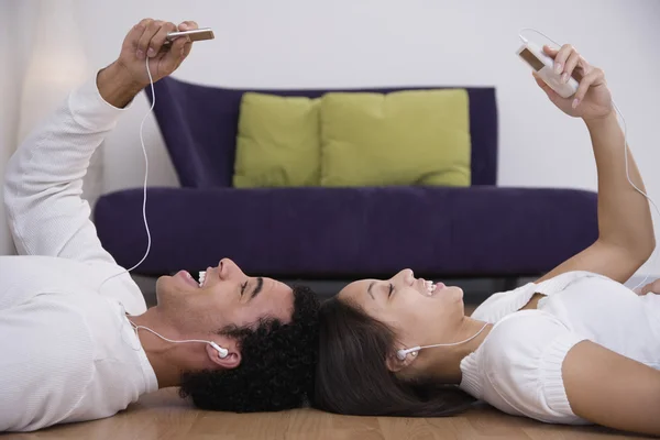 African couple listening to mp3 players