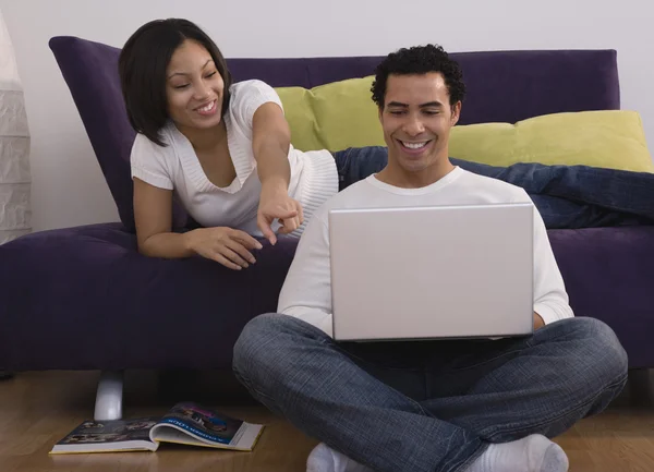 African couple looking at laptop