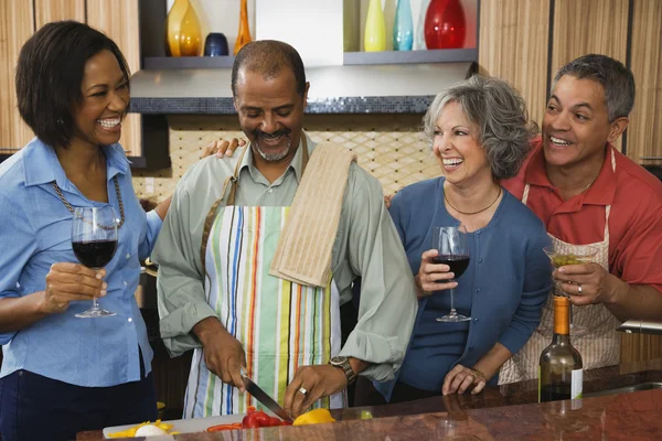 Multi-ethnic friends drinking wine and preparing food