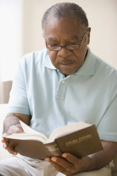 Senior African man reading bible