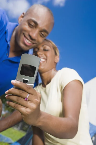 African couple looking at cell phone